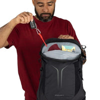 Black hiking backpack with front zipper pocket and small accessory pouch