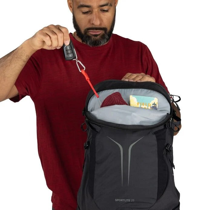 Black hiking backpack with front zipper pocket and small accessory pouch