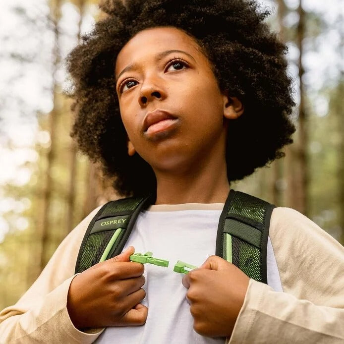 Person wearing a Osprey backpack in a forest setting