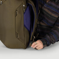 Olive travel pack side pocket with dark blue interior panel and zipper pulls