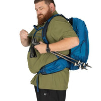Man with a blue backpack and hiking gear on a white background