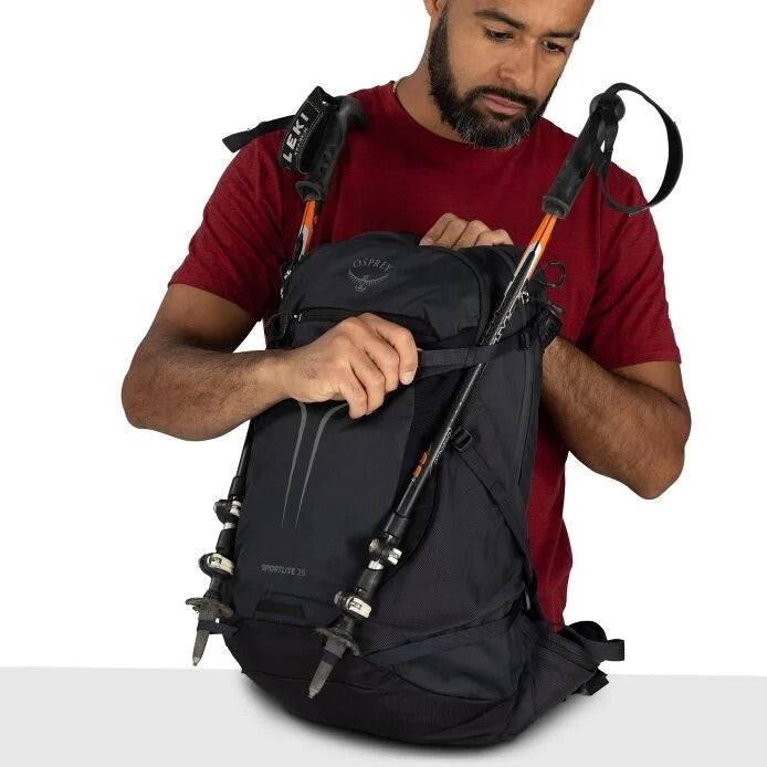 Black hiking backpack with side straps and trekking pole holders attached