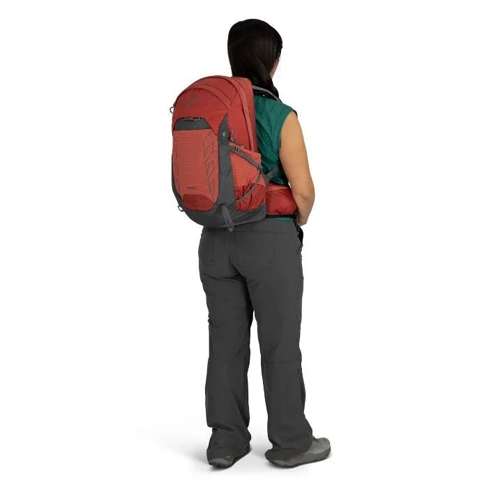 Person wearing a red and gray backpack on a white background