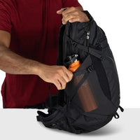 Black hiking backpack with mesh side panel and adjustable shoulder/strap webbing