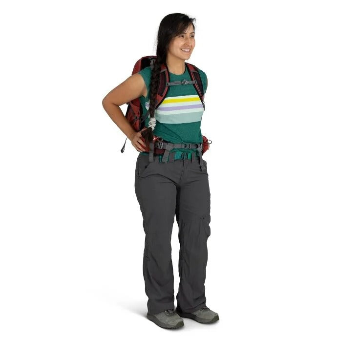 Person wearing hiking gear with a backpack on a white background