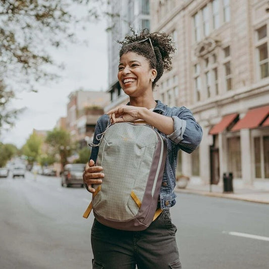 Woman with a backpack walking on a city street