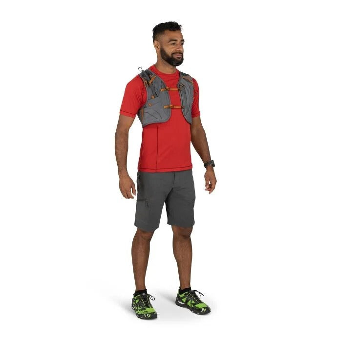 Man wearing a red shirt, gray shorts, and a gray backpack on a white background