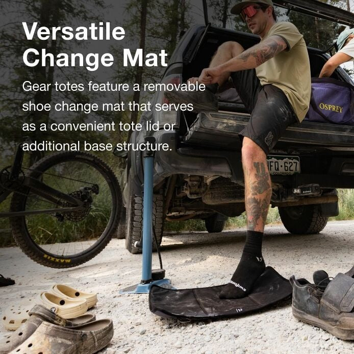 Person using a shoe change mat on the ground next to a vehicle with text about versatile change mats.