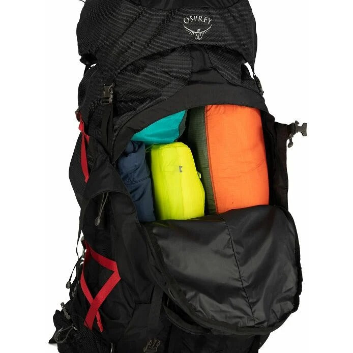 Black Osprey backpack with colorful items inside on a white background