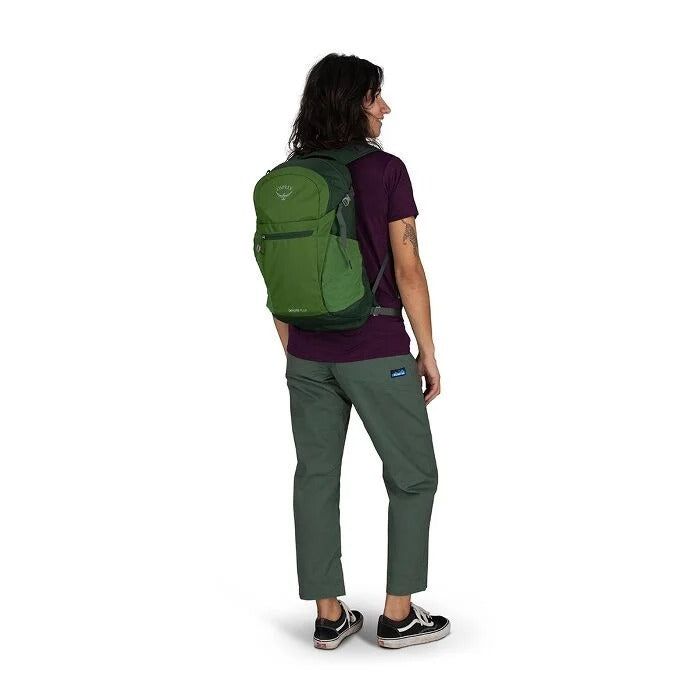 Person wearing a green backpack on a white background