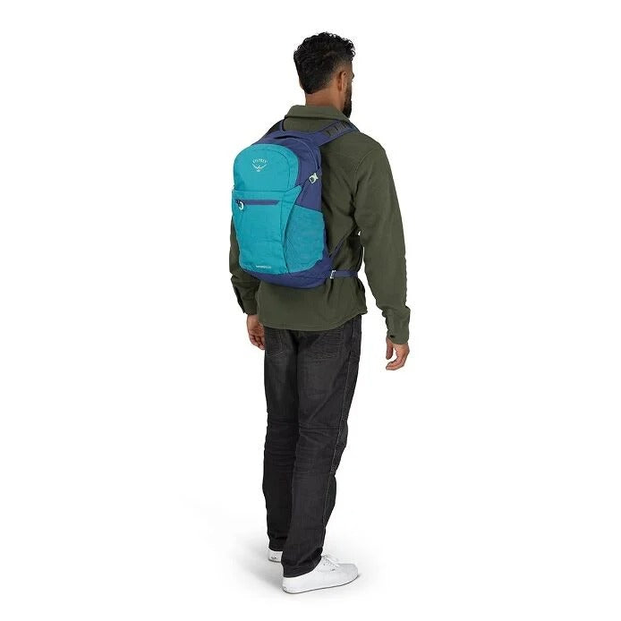 Person wearing a blue and black backpack on a white background