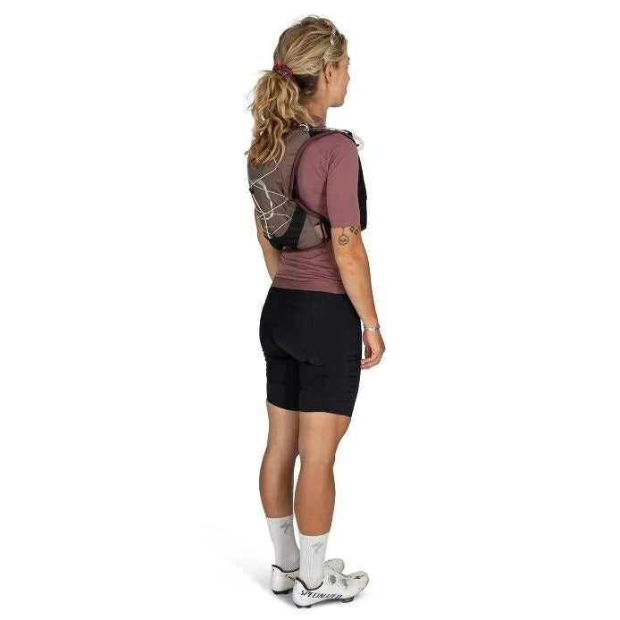 Person wearing a backpack and cycling shorts on a white background