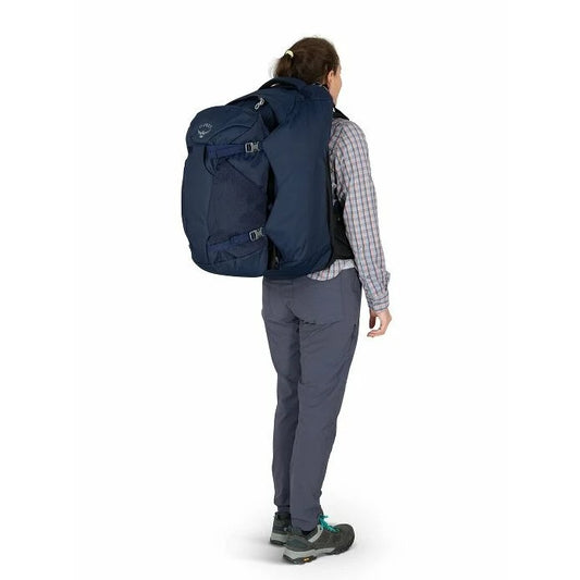 Person wearing a large navy backpack on a white background
