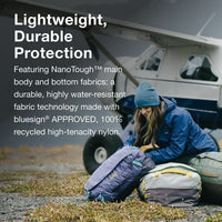 Person packing a backpack with text about lightweight, durable protection and water-resistant fabric.
