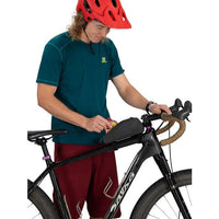 Person adjusting a bike with a red helmet on a white background