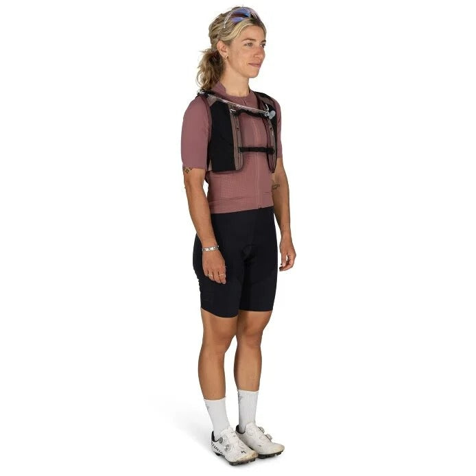 Woman wearing a black backpack and cycling shorts on a white background