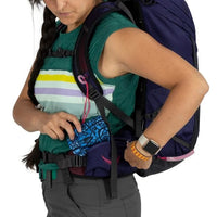 Person wearing a large backpack with a colorful shirt underneath