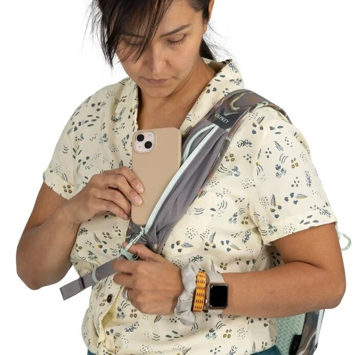 Person using a smartphone with a backpack on a white background