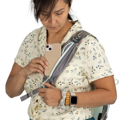 Person using a smartphone with a backpack on a white background