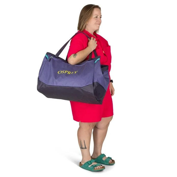 Woman carrying an Osprey bag on a white background